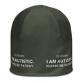 Olive stretch SIGNAL beanie, front with I AM AUTISTIC. PLEASE BE PATIENT. around the band; digital mockup of earlier artwork.