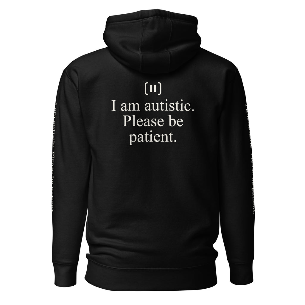 Supplier back mockup of the black SIGNAL Autism Hoodie, with a cream mark above the serif message "I am autistic. Please be patient."