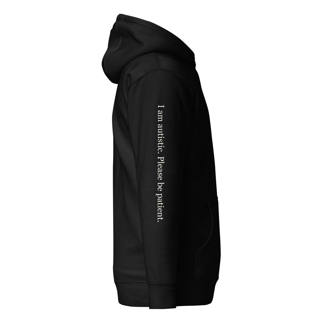 Supplier right-side mockup of the black SIGNAL Autism Hoodie, with cream serif sleeve text reading "I am autistic. Please be patient."