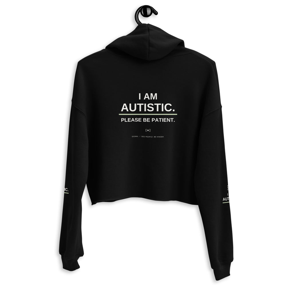 Black women’s cropped autism hoodie, back with I AM AUTISTIC. PLEASE BE PATIENT.; digital mockup of earlier artwork.