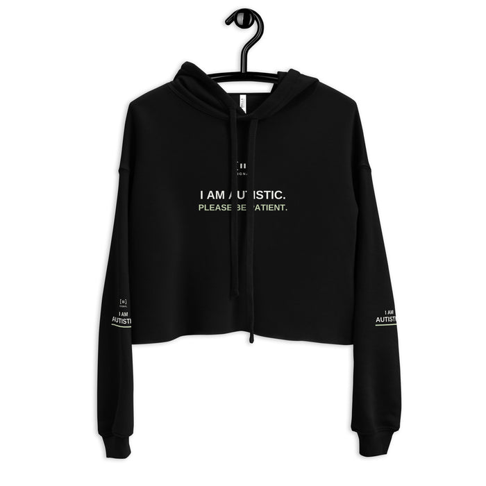 Black women’s cropped SIGNAL hoodie, front with drawstrings crossing the autism message; digital mockup of earlier artwork.